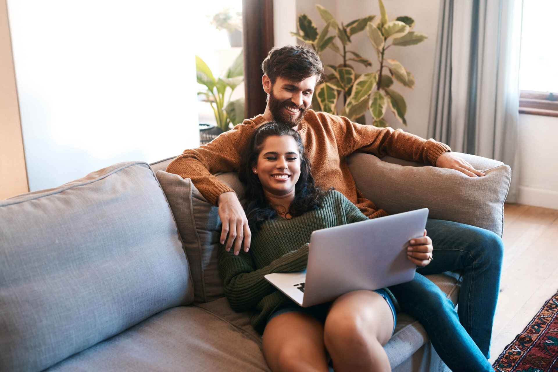 a couple on a laptop at ajax omaha apartments